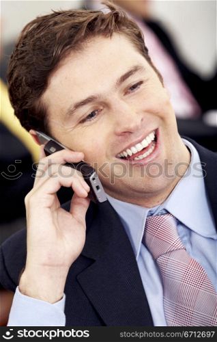 Business man on the phone smiling at his office