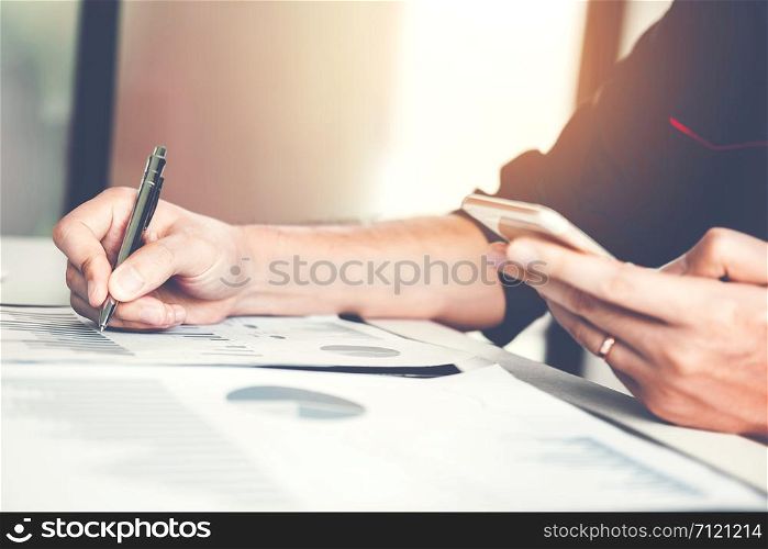 Business man pointing his ideas and writing business plan at workplace,man holding pens and papers, making notes in documents