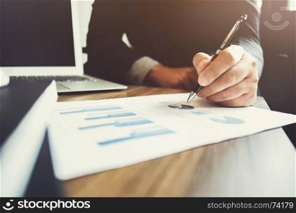 business man pointing on data paper working with investment data or company growth valuation, selective focus