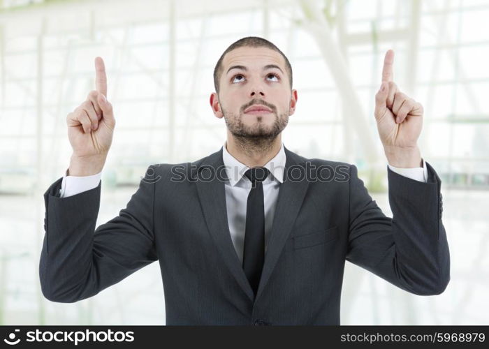 business man pointing up with his fingers at the office
