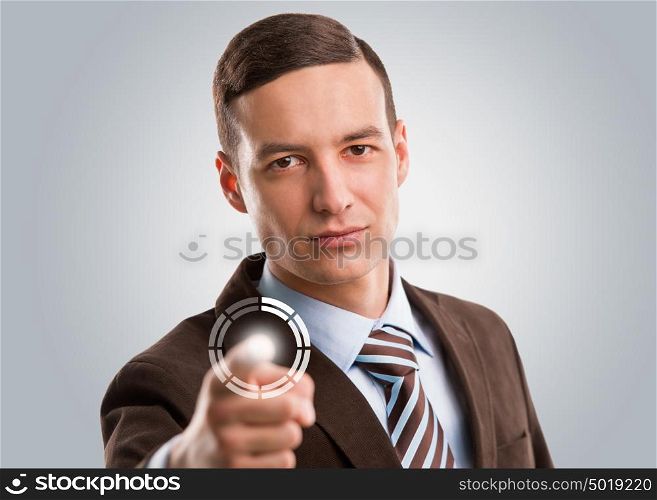 Business man pushing virtual button on touch screen