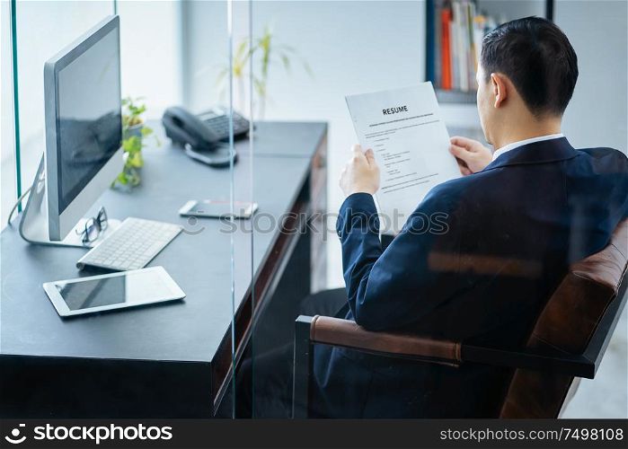Business man review his resume on his office,Seleted focus.