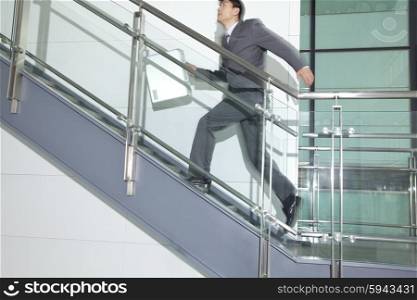 Business Man Running Up Stairs