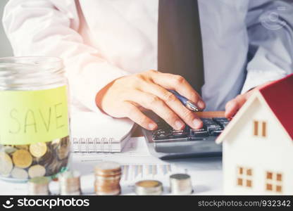 Business man Save money for home cost