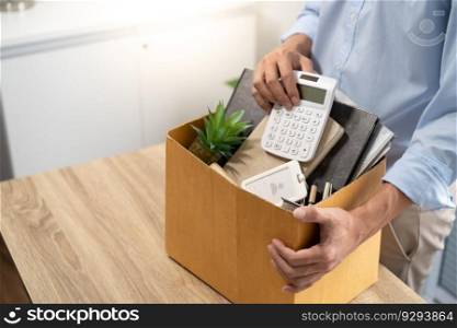 Business man sending resignation letter and packing Stuff Resign Depress or carrying business cardboard box by desk in office. Change of job or fired from company resign concept