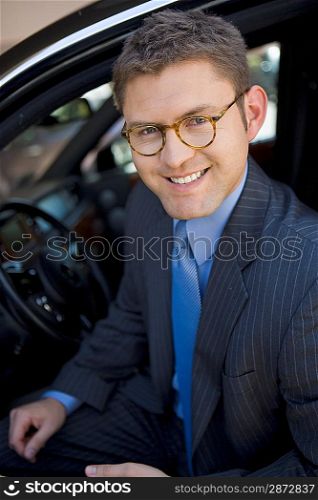 Business man sitting in car, portrait