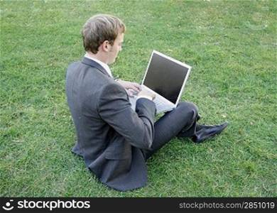 Business man sitting in the park