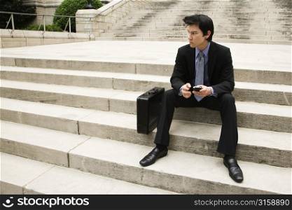 Business man sitting on stairs
