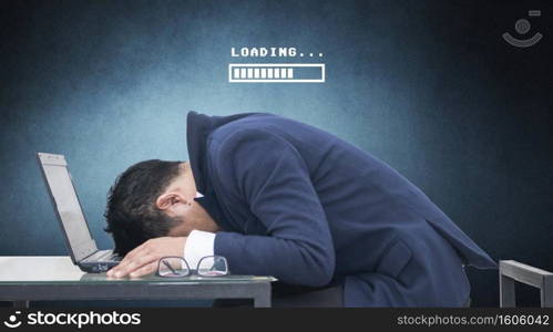 Business man sleeping on his laptop in his office