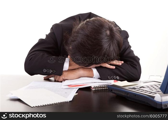 Business man sleeping over the desk, isolated over white