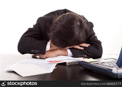 Business man sleeping over the desk, isolated over white