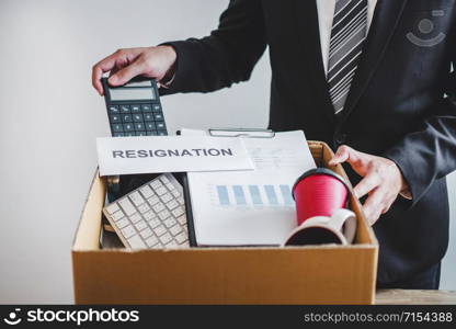 Business man stressing with resignation letter for quit a job packing the box and leaving the office , Resignation concept