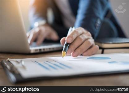 Business Man Studying accountant working with financial data Graph Report Concept.