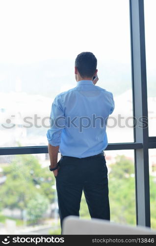 business man talking by cellphone in office