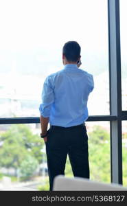 business man talking by cellphone in office