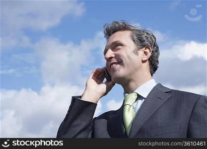 Business man talking on mobile phone outdoors