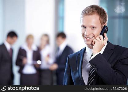 Business man talking on the phone in the foreground