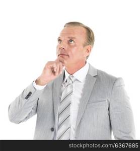Business man think looking up. Handsome mature business man think looking up to empty copy space, hold hand on chin isolated over white background