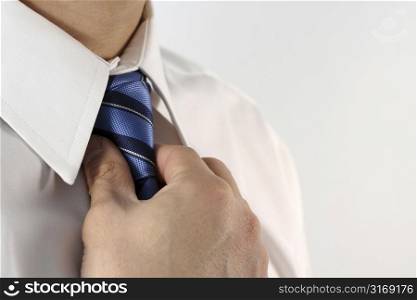 Business man tying a tie