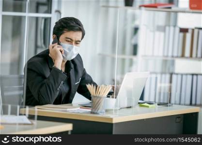 Business man use smartphone and wearing face mask for protect coronavirus covid-19 pandemic. Social and business distancing new normal lifestyle.
