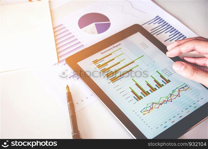 Business man Using digital tablet with Report chart