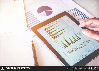 Business man Using digital tablet with Report chart