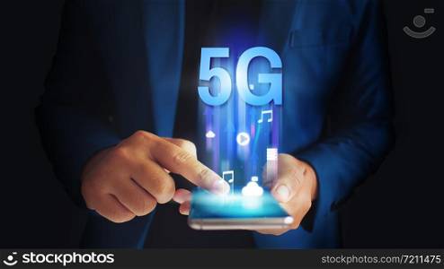 Business man using mobile smartphone with 5G icons flow on virtual screen concept. 5G High speed internet network.