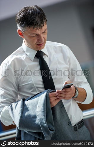 business man using phone at modern office space