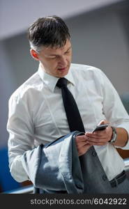 business man using phone at modern office space