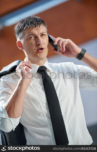 business man using phone at modern office space