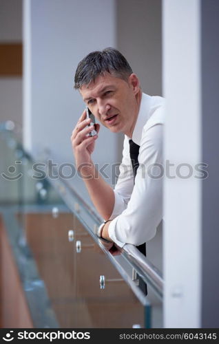 business man using phone at modern office space