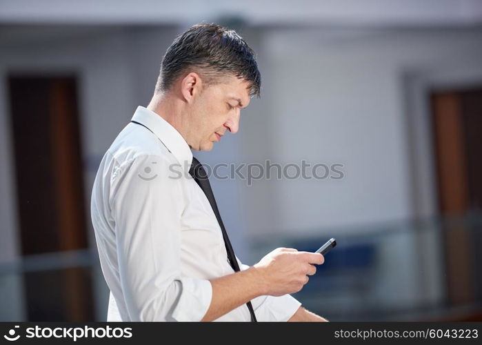 business man using phone at modern office space