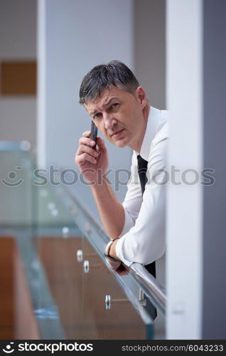 business man using phone at modern office space