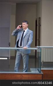 business man using phone at modern office space