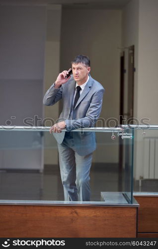 business man using phone at modern office space