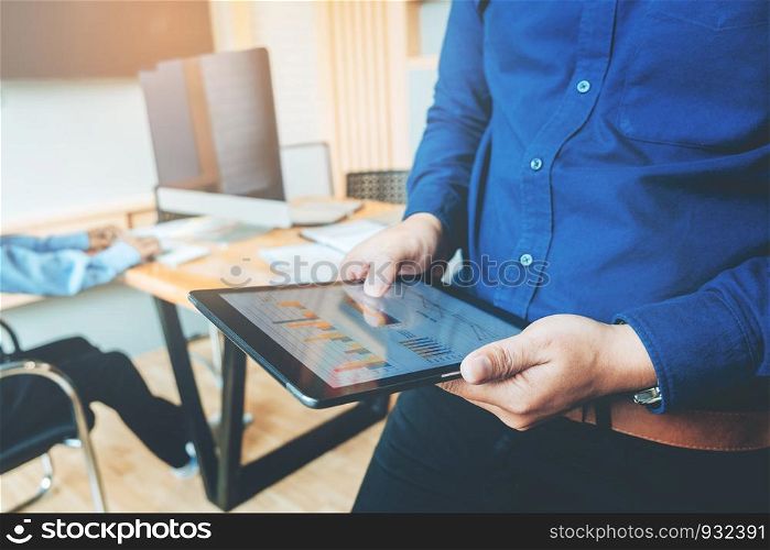Business man using tablet before meeting in office