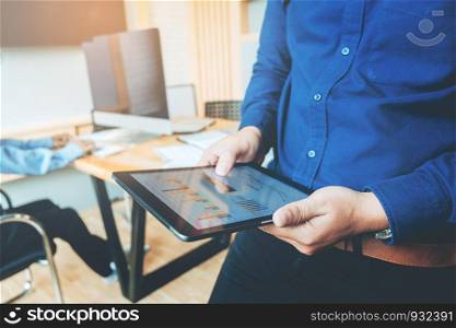 Business man using tablet before meeting in office