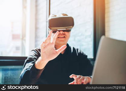 Business man using Virtual Reality simulator headset and developing a new project