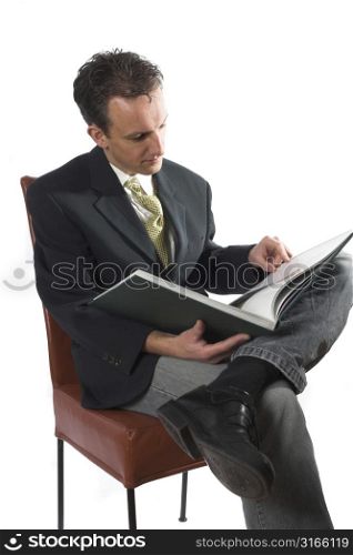 Business man waiting for his next meeting and reading a book to kill the time