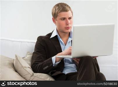 Business man watching and working on computer laptop at home