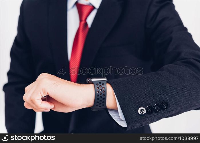 Business man wearable and he seeing smart watch on hand, the smartwatch is modern technology design isolated on white background