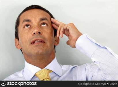 business man with a pensive look over a light green background