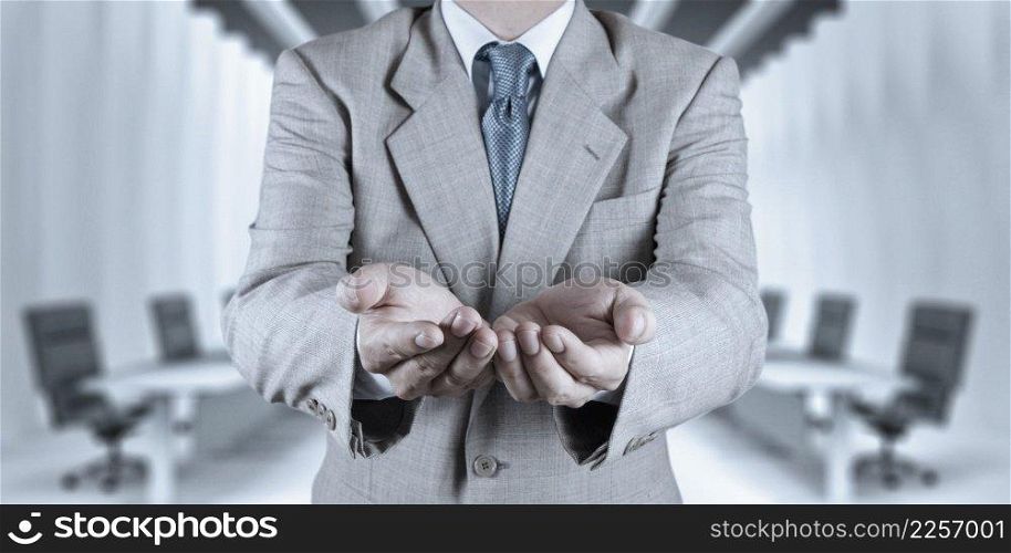 business man with an open hand as showing something concept