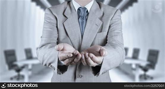 business man with an open hand as showing something concept