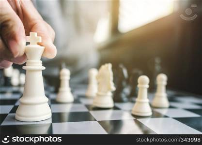 business man with chess board game, strategy and competition.
