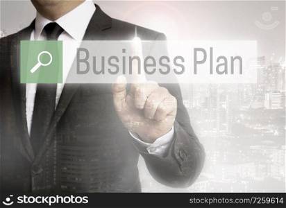 Business man with city background business plan browser.. Business man with city background business plan browser