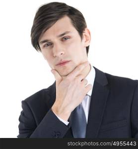 Business man with hand on chin. Portrait young business man holding hand in his chin while looking pensively at the camera isolated on white background
