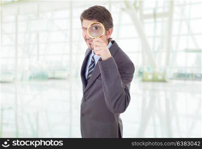 business man with magnifying glass at the office
