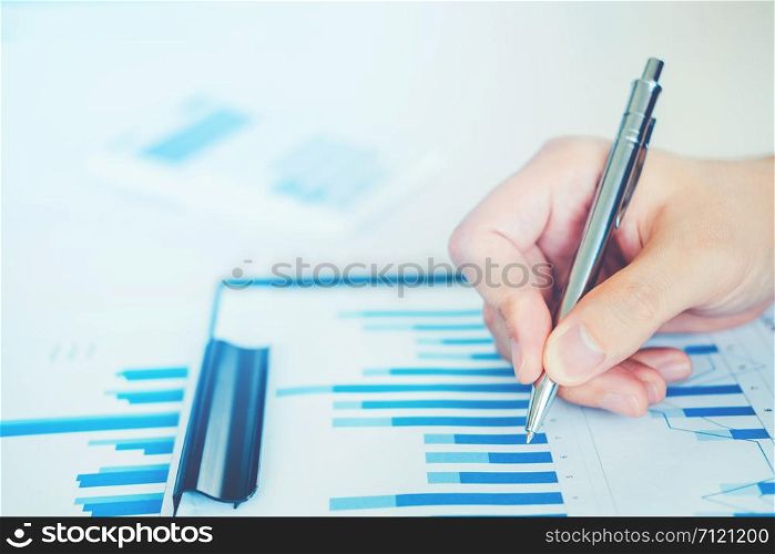 Business man with Report chart in office planning new business project