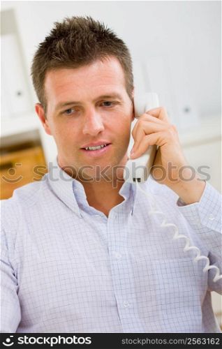 Business man working at home, calling on phone.